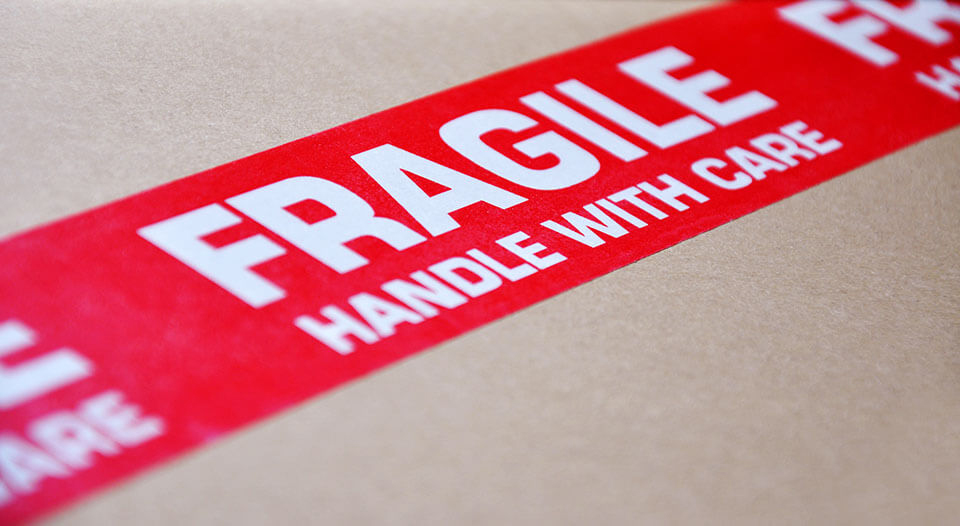 carboard box with fragile across the top in red