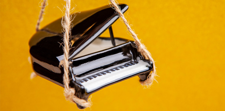Piano ornament hanging from string